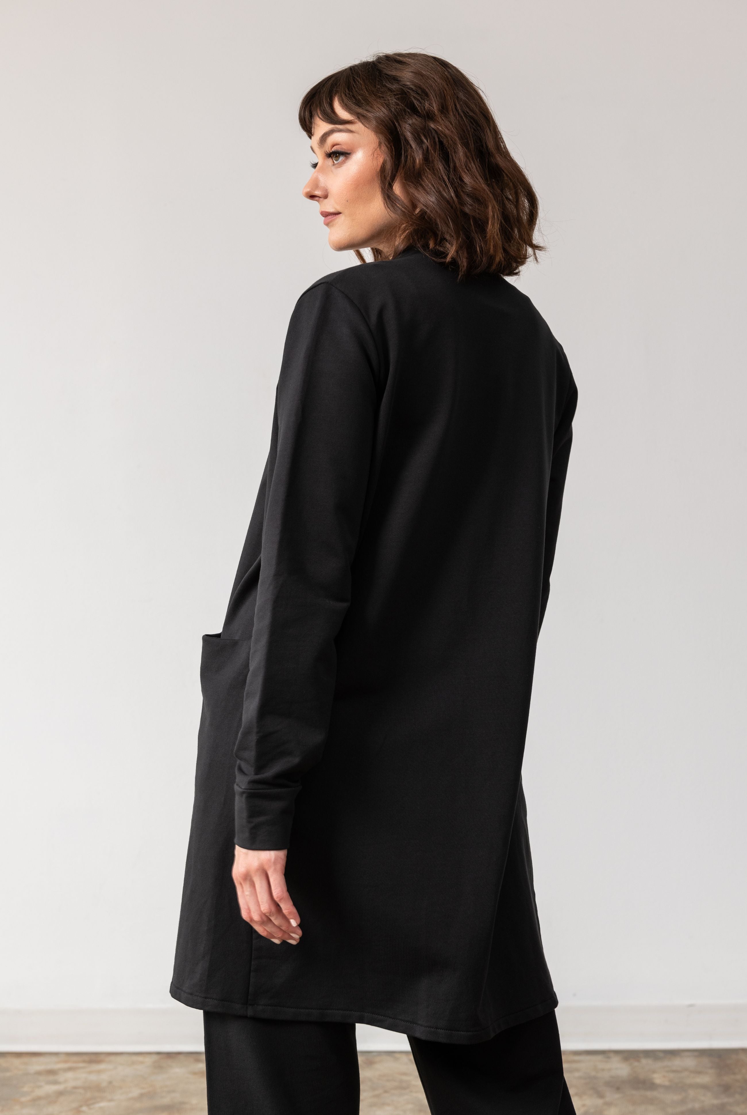 Woman shown wearing black cardigan